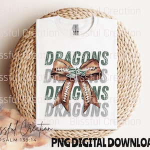 May include: A white t-shirt with a green, brown, and white graphic design of a football-themed bow with the text "DRAGONS" repeated three times. The text "PSALM 139:14" is at the bottom of the image.