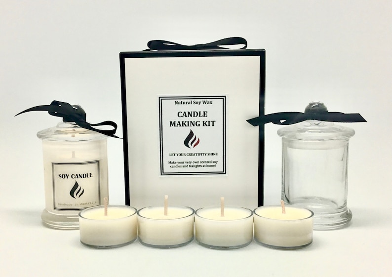 May include: A candle making kit with natural soy wax. The kit includes four small glass candle jars, two larger glass jars with lids, and a box with the text "Natural Soy Wax Candle Making Kit Let Your Creativity Shine Make your very own scented soy candles and tealights at home!"