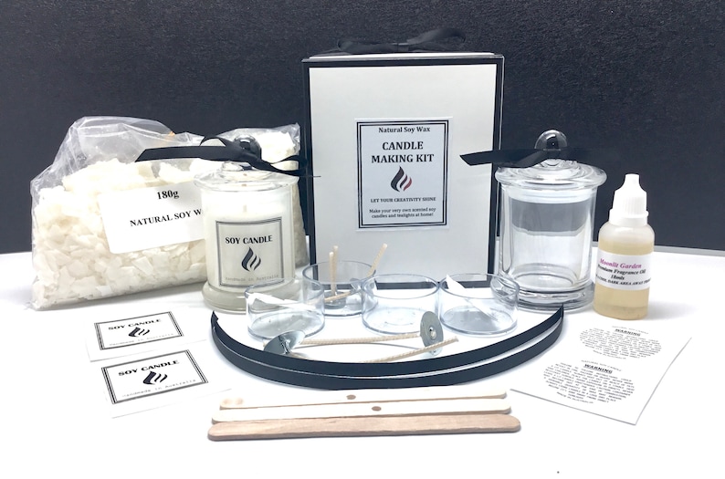 May include: A candle making kit with natural soy wax, a glass jar, wicks, and a bottle of fragrance oil. The kit includes instructions and labels for making candles. The kit is packaged in a black box with a white label that says "Natural Soy Wax Candle Making Kit".