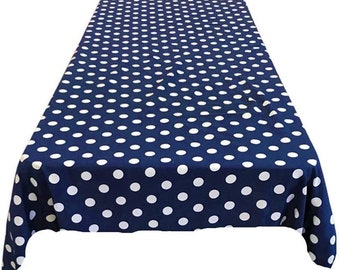 May include: A navy blue rectangular tablecloth with a pattern of evenly spaced white polka dots. The tablecloth is made of a smooth fabric and is suitable for a dining table or other surface.