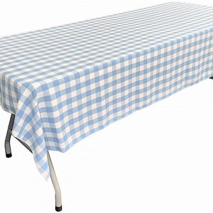 May include: A blue and white checkered tablecloth with a white background and blue squares. The tablecloth is draped over a table with metal legs.