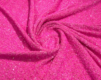 May include: Close-up of a vibrant pink sequin fabric. The fabric is heavily textured with small, reflective sequins, creating a shimmering effect. The material is draped, showing folds and shadows that add depth to the image. Ideal for fashion or craft projects.
