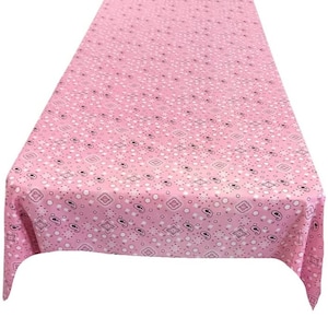 May include: Pink tablecloth with a white paisley pattern.