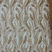 Fiesta Design Embroider and heavy beading on a mesh lace-sold by the yard. Off White