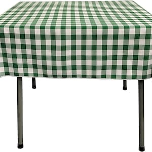 May include: Green and white checkered tablecloth on a table with metal legs.