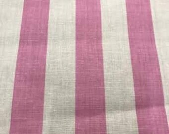 May include: Close-up of a fabric with vertical stripes. The stripes alternate between a light pink and off-white color. The fabric appears to be a linen or cotton blend, with a slightly textured surface. The fabric is folded at the top.