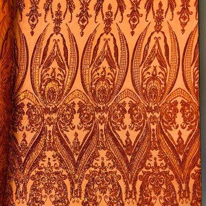 Empire damask design with sequins embroider on a 4 way stretch mesh fabric-sold by the yard. Burnt Orange