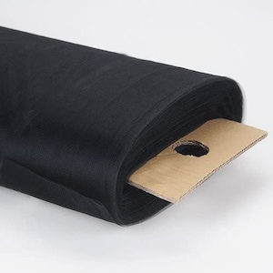 May include: A roll of black tulle fabric, a sheer and delicate material often used for crafting, decorating, and special events.
