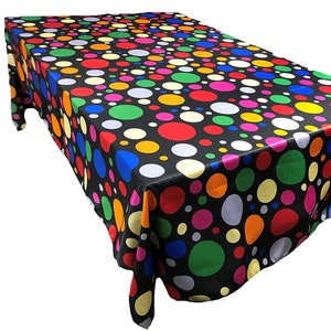 May include: A rectangular black tablecloth with a vibrant pattern of colorful polka dots in red, yellow, green, blue, pink, and orange. The tablecloth is made of a shiny, satin-like material.