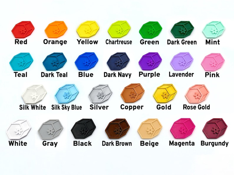 May include: A collection of colorful, hexagonal-shaped charms, each with a floral design. The charms are in various colors, including red, orange, yellow, green, blue, purple, and metallic shades like gold and silver. Each charm has a color name printed below it.