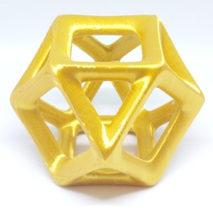 May include: A gold-colored, geometric, open-frame cube with a hollow center. The cube is made of a smooth, shiny material.