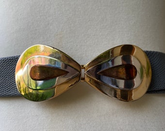May include: A gray elastic belt with a gold-tone, double-loop buckle in the shape of a teardrop.