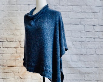 May include: A blue knitted poncho with a cowl neck and a slightly asymmetrical hem.