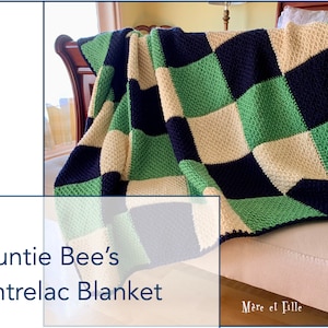 May include: A green, beige, and navy blue crocheted blanket with a checkered pattern. The blanket is folded and draped over a couch. The text "Auntie Bee's Entrelac Blanket" is visible in the lower left corner of the image. The text "Mère et Fille" is visible in the lower right corner of the image.