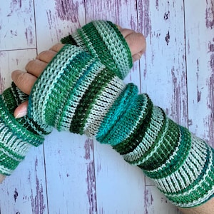 May include: Green and white striped knit fingerless gloves. The gloves are made with a soft yarn and have a comfortable fit.