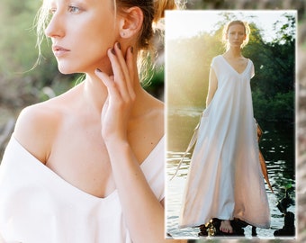 May include: Two women wearing white linen dresses. The woman on the left is standing in a forest, while the woman on the right is standing in a river.