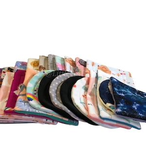 May include: A selection of patterned fabric squares, possibly reusable pads or cloths, in various designs. Patterns include flowers, cats, and rainbows. The edges are trimmed with different colours.