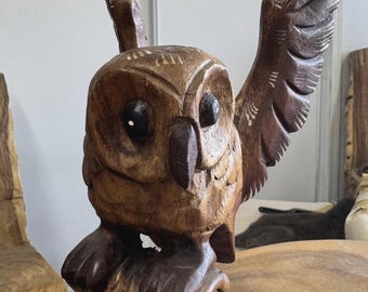 wooden owl spreading wings