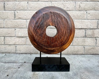 Round rustic wood art on stand