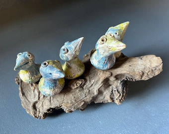 Ceramic Bird sculpture on drift wood