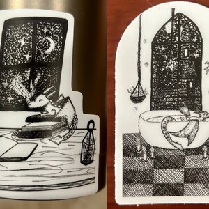 May include: Two black and white illustrations of a dragon. The first illustration shows a dragon curled up on a stack of books, looking out a window with stars and a crescent moon. The second illustration shows a dragon in a bathtub with bubbles, with a window behind it.