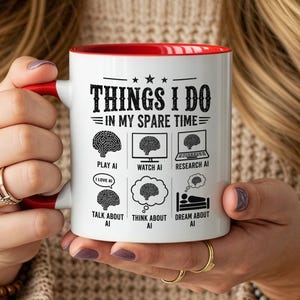 May include: A white ceramic mug with a red interior and handle, featuring black text that reads THINGS I DO IN MY SPARE TIME followed by six illustrations of brains with labels: PLAY AI, WATCH AI, RESEARCH AI, TALK ABOUT AI, THINK ABOUT AI, and DREAM ABOUT AI.