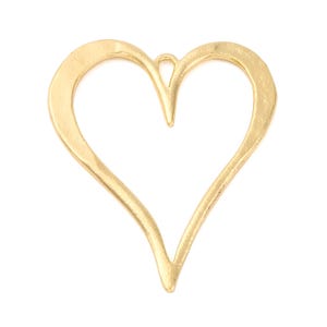 May include: A gold-colored metal heart-shaped pendant with a textured, matte finish. The heart is an open-frame design with a small, integrated loop at the top center for attachment, featuring irregular, organic edges throughout the frame.