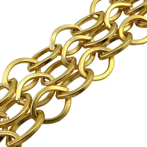 May include: Close-up of a gold-colored chain with oval links. The chain is made of a shiny, metallic material and is set against a white background. The links are interlocked, creating a textured pattern. The chain appears to be a jewelry item.