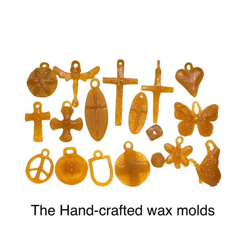 May include: A collection of amber-colored wax molds in various shapes, including crosses, butterflies, hearts, and circles. The text "The Hand-crafted wax molds" is at the bottom of the image.