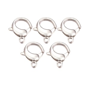 May include: A set of three ceramic mugs with a speckled, matte finish. The mugs are in shades of cream, light brown, and dark brown. Each mug has a simple, minimalist design, perfect for coffee or tea.