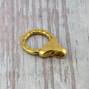 May include: A set of three ceramic mugs with a speckled, cream-colored glaze. Each mug features a different hand-painted floral design in shades of blue, green, and yellow. The mugs have a simple, rounded shape and a comfortable handle.