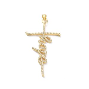May include: A gold-colored pendant in the shape of a cross with the word "love" written in a cursive font. The pendant is encrusted with small, clear gemstones, adding sparkle to the design. The cross has a loop at the top for a chain.