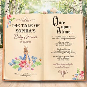 May include: An open book with cream-colored pages featuring watercolor illustrations of a rabbit and flowers. The left page reads The Tale of Sophia's Baby Shower and the right page contains a poem starting with Once Upon A Time.