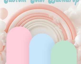 May include: Three arched panels in pastel pink, light blue, and mint green stand in front of a large, multi-layered peach and cream rainbow backdrop. The text "Custom Color Backdrop" is displayed in a light blue, retro-style font at the top.