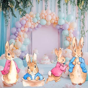 May include: Four brown rabbit figurines with different colored clothing. The rabbits are standing in front of a pastel pink background with a balloon arch made of pastel colored balloons.