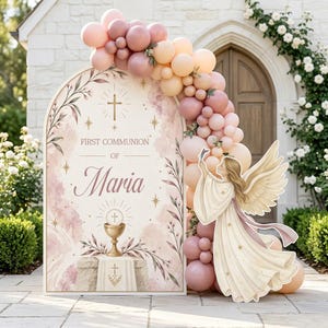 May include: An arched First Communion sign for Maria featuring a gold chalice, a cross, and botanical illustrations, decorated with a large balloon garland in shades of pink and cream, accompanied by a cutout of an angel with wings.