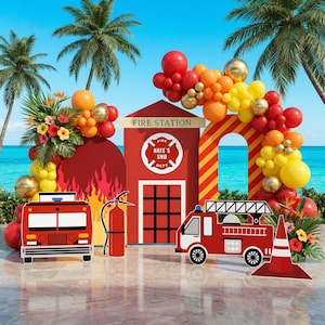 May include: A fire station themed party backdrop featuring a red structure with the text FIRE STATION and NATE'S SND DEPT, flanked by balloon arches in red, orange, yellow, and gold, with cutouts of a fire truck, fire engine, and fire extinguisher.