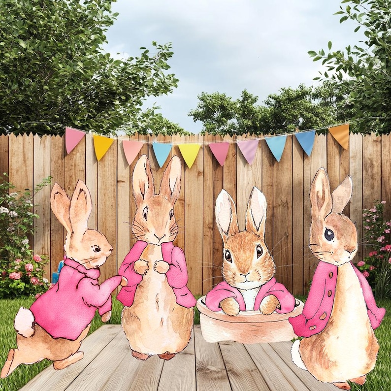 May include: Four brown rabbits wearing pink jackets stand on a wooden deck. The rabbits are in various poses, with one rabbit sitting in a brown bowl. A colorful banner hangs above the rabbits.