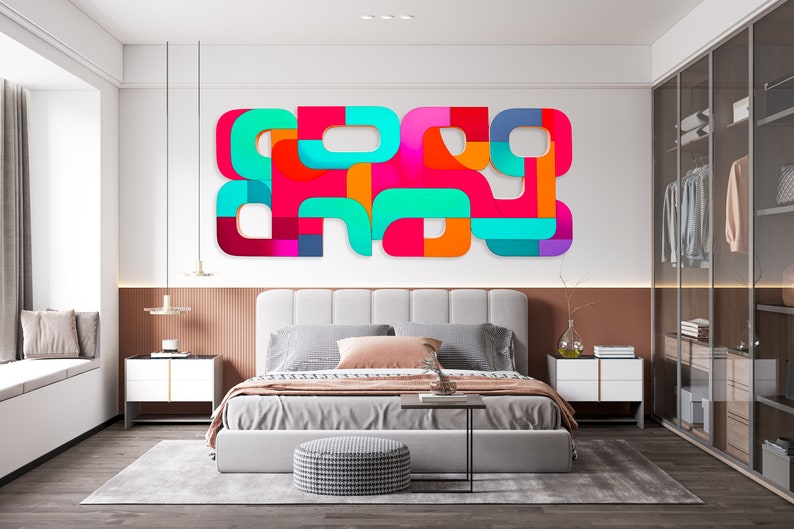 May include: A modern bedroom with a white bed, a gray rug, and a colorful abstract wall art piece. The art piece is made of geometric shapes in shades of pink, orange, blue, and green.