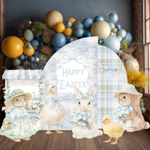 May include: A decorative display featuring a balloon arch in blue, yellow, and cream tones above a backdrop with the text Happy Easter. The scene includes illustrations of rabbits, a duck, and a chick, alongside a flower cart graphic.