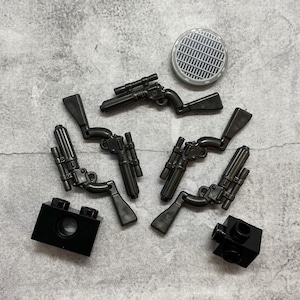 May include: A set of black Lego Star Wars blaster guns, including a repeating blaster and a single-shot blaster. The set also includes two black Lego bricks.