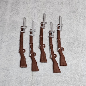 May include: Six brown toy rifles with silver bayonets. The rifles are all the same size and shape, and they are arranged in a row.