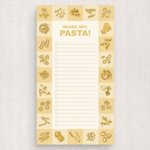 May include: A white notepad with a gold border and a checklist. The notepad has the text "READY, SET, PASTA!" at the top. The border is decorated with different types of pasta.