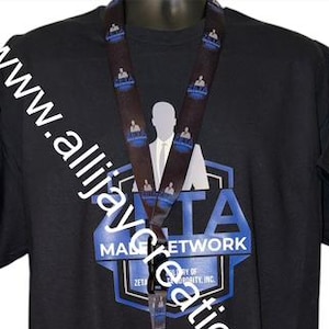 May include: Black t-shirt, drawstring bag, and lanyard set. The shirt and bag feature a blue and white logo with the text "ZETA MALE NETWORK". The lanyard has a repeating pattern of the logo and a silhouette.