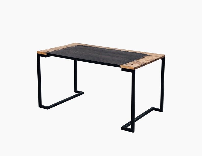 May include: A black metal table with a rectangular wooden top. The top is stained black with a natural wood edge.