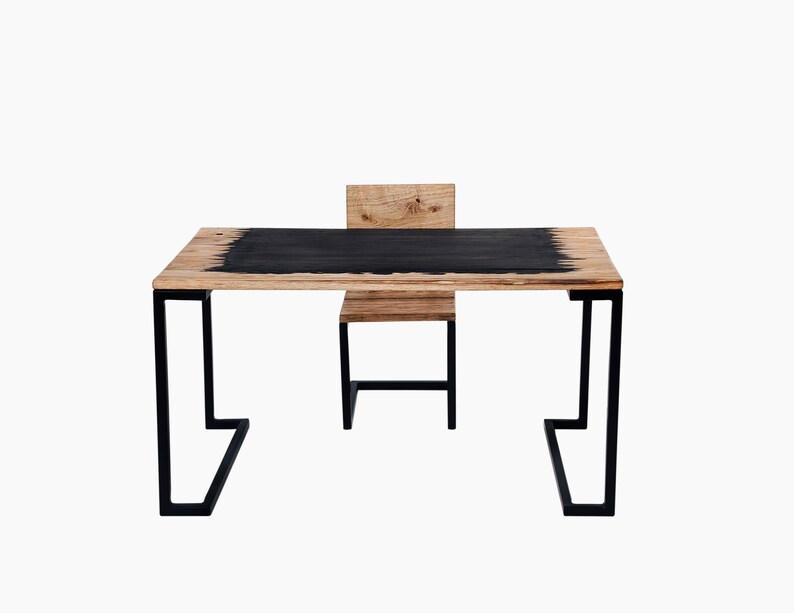 May include: A black and wood desk with a black metal frame and a matching chair. The desk has a black top with a wood grain pattern.