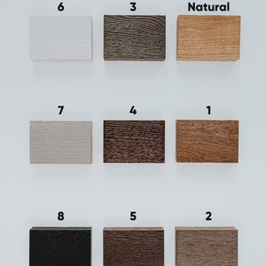 May include: Nine wood samples in different colors and finishes, labeled with numbers 1 through 8 and the word "Natural".