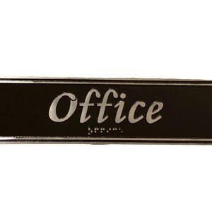 May include: Black rectangular sign with a silver border and the word "Office" in a silver script font.
