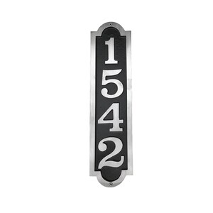 May include: A vertical silver and black house number plaque with the numbers 1542 in white.