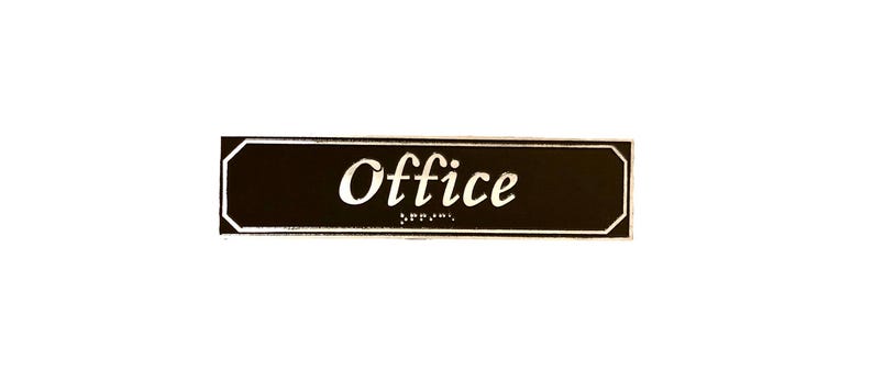 May include: Black rectangular sign with rounded corners and white trim. The sign says "Office" in white cursive lettering.